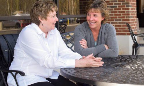 100 Women Who Care conversation at a table