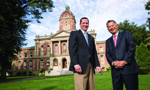 Pete McCown and Dzung Nguyen standing in front of the County Courthouse