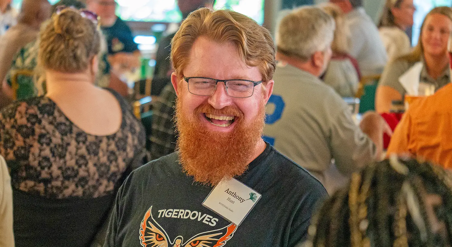 An attendee of a CEO Roundtable laughs